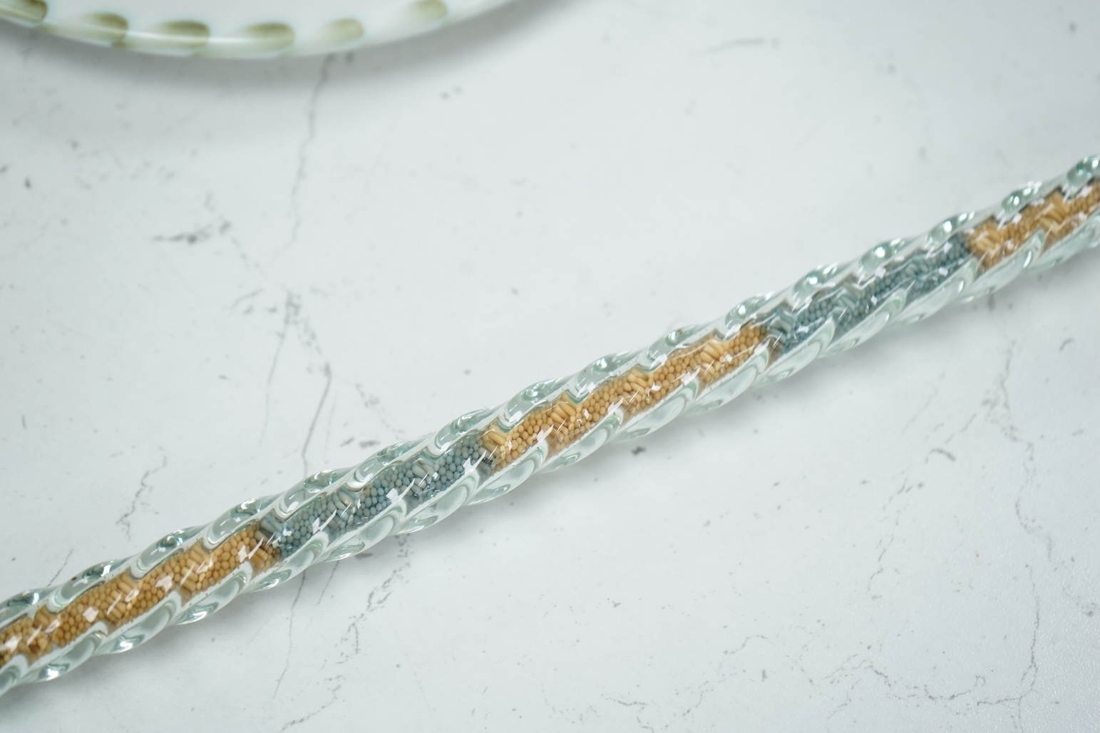 A 19th century Nailsea spiral walking stick, decorated with fine coloured beads, 128cm in length